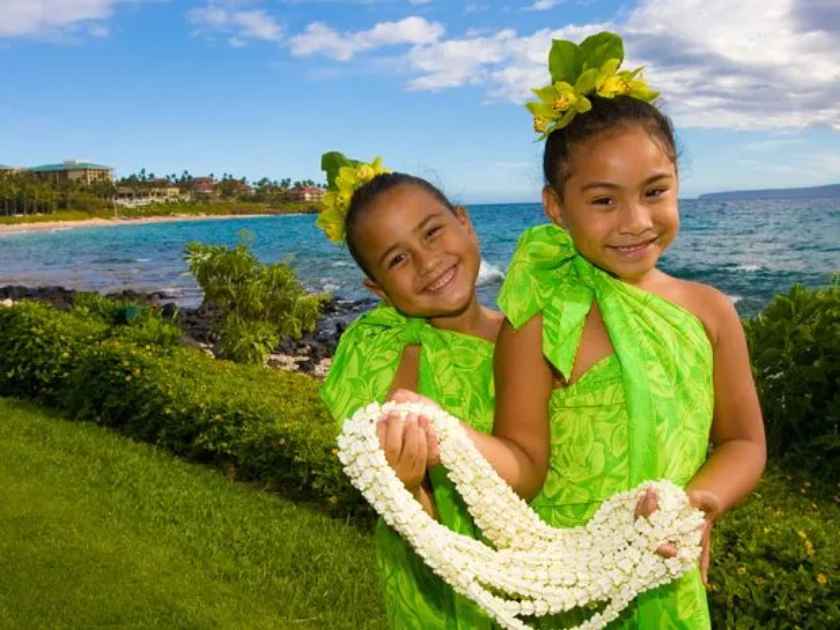 Polynesian kids holding a Pikake Lei.