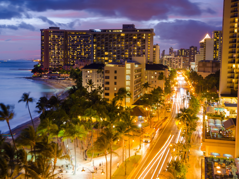 Waikiki Beach and Kalakaua Avenue in Honolulu, HI at night
