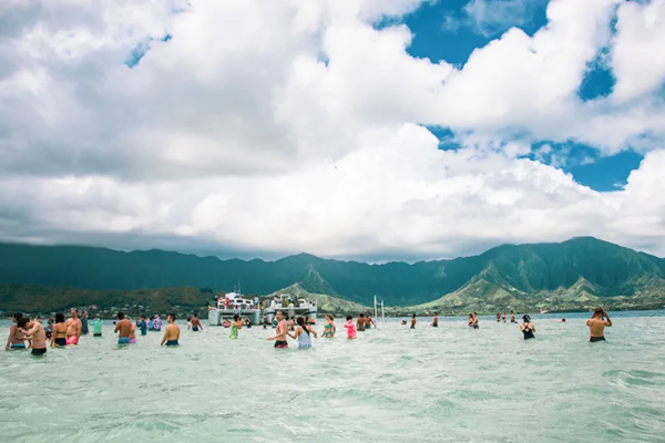 Visitors enjoying water activities by Captain Bob's Kaneohe Bay Cruise