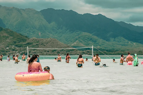 Visitos enjoying volleyball at Kaneohe Sandbar