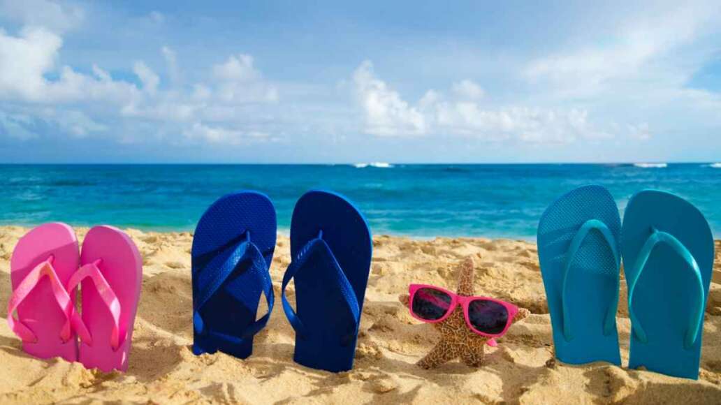 Flip flops and starfish with sunglasses on sandy beach in Hawaii, Kauai
