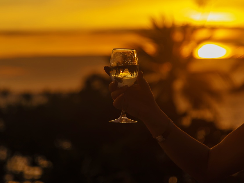 With glasses of wine at sunset. Selective focus. Drink.