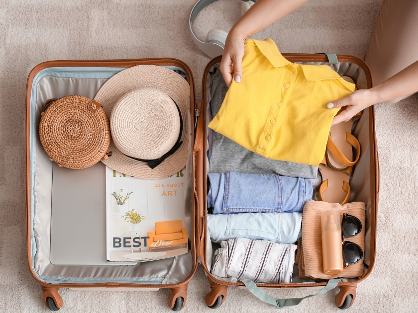 Woman packing suitcase at home. Travel concept