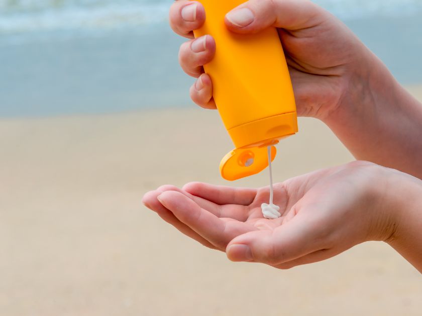 Hands applying sunscreen