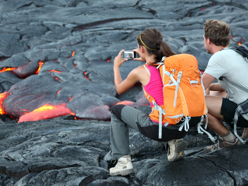 Hawaii lava tourist. Tourists taking photo of flowing lava from Kilauea volcano around Hawaii volcanoes national park, USA.