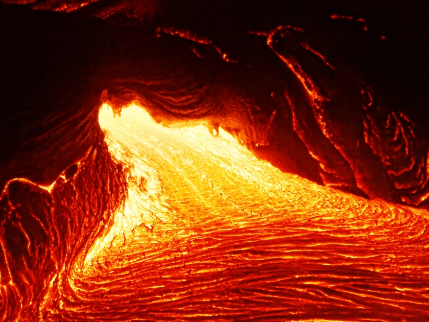 Detailed view of an active lava flow, hot magma emerges from a crack in the earth, the glowing lava appears in strong yellows and reds - Hawaii, Big Island, Kilauea volcano, Puna district, Kalapana