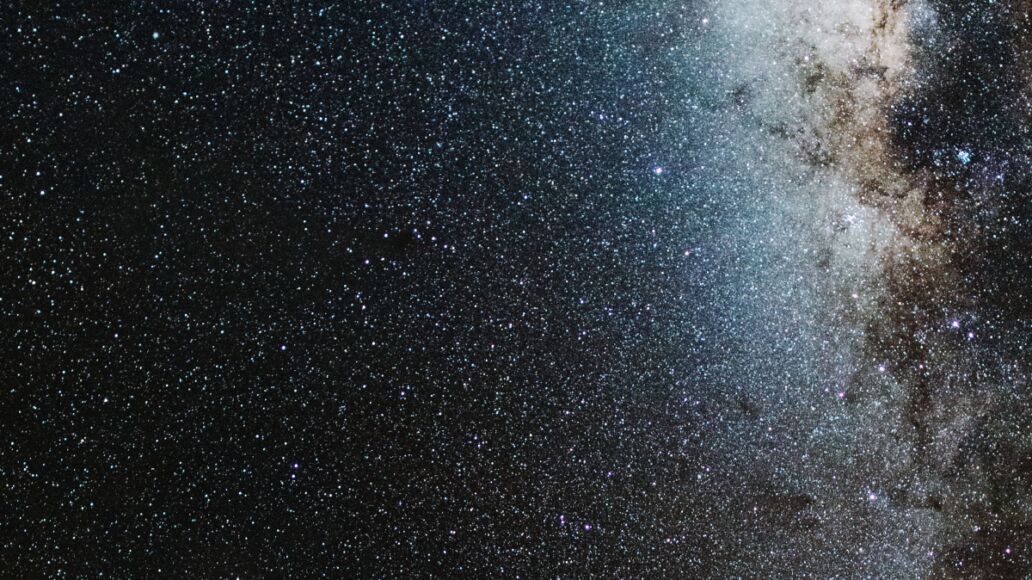 View of Milky Way solar system in night sky over volcanic pu'u hill on the slope of sacred Mauna Kea mountain in Hawaii