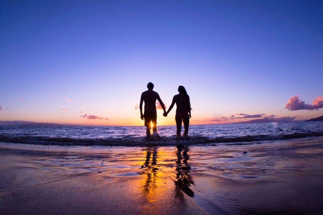 Romantic,Couple,Enjoying,A,Beach,Walk,At,Sunset