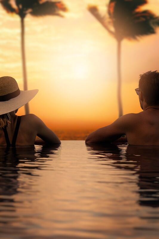 Couple,Enjoying,Sunset,From,Infinity,Pool,At,Tropical,Bali,Island