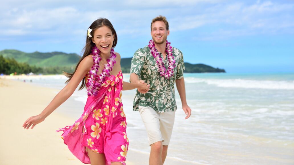 Happy,Couple,Having,Fun,Running,On,Hawaii,Beach,Vacations,In