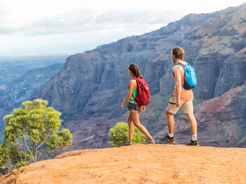 Hikers,Couple,Hiking,In,Mountains,Landscape.,Woman,And,Man,Walking