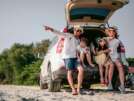 Happy asian family enjoying road trip with their favorite car. Parents and children are traveling the way to the sea or ocean.Holiday and travel family concept, Summer vacations.