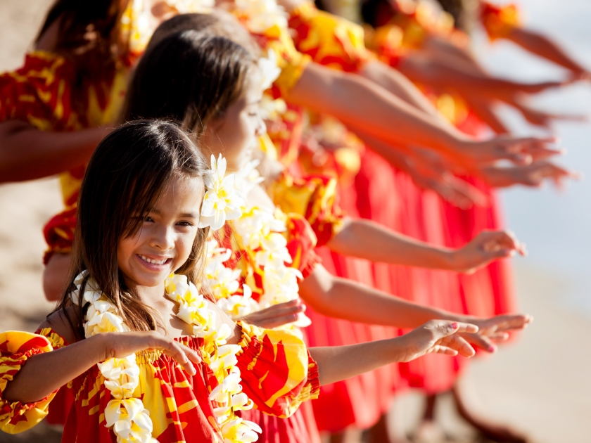 Hula girls on the beach with Hands raised