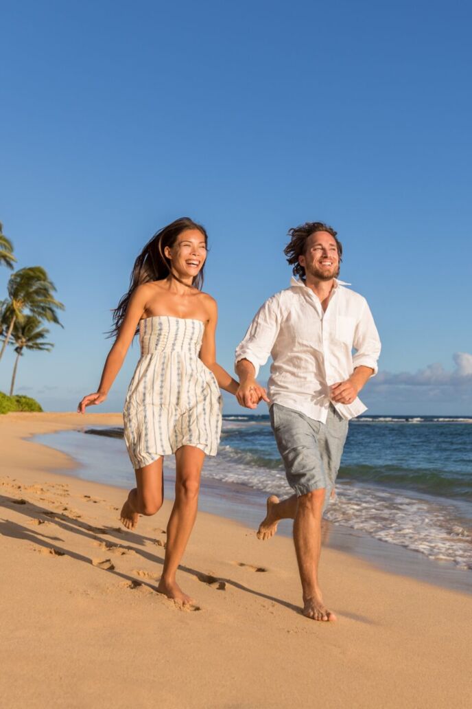 Happy,Couple,Having,Fun,Running,Together,On,Beach.,Young,Multiracial