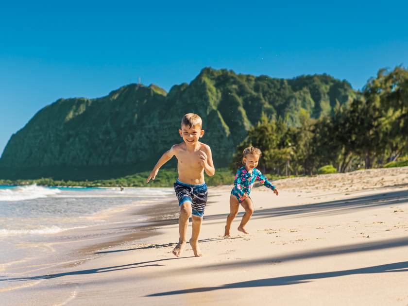 Happy children ring playing on a Hawaii beach