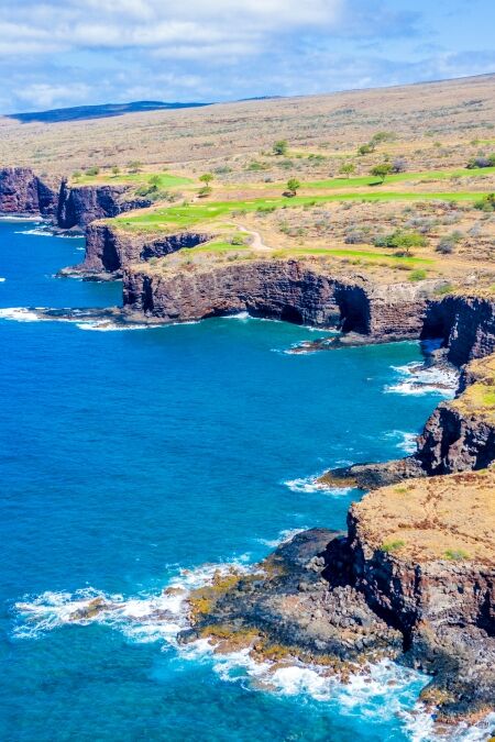 Aerial view of Lanai, Hawaii looking west at the rocky cliffside bordering the Pacific Ocean