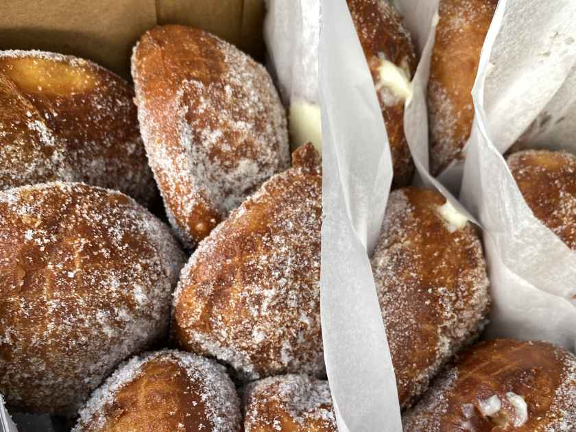 A bakery box of fresh-made malasadas - Portuguese donuts popular in Hawaii