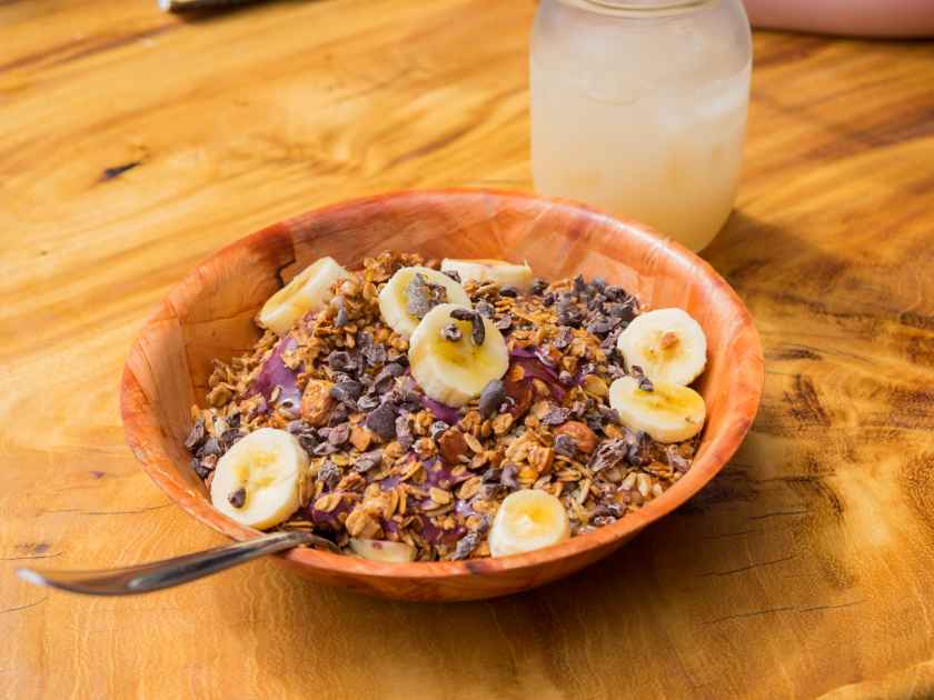 Acai bowl with granola, bananas, and hone at a restaurant on tropical Oahu Hawaii.