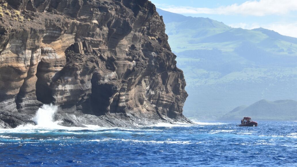 A beautiful shot of the Molokini crater washed by the Pacific ocean waves on a sunny day in Hawaii