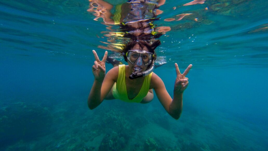 Underwater snorkeling woman in Maui Hawaii