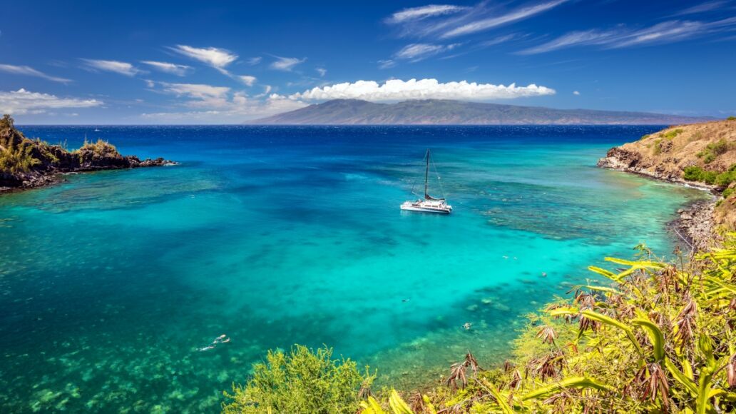 Snorkeling in the turquoise sea at Honolua Bay on the Island of Maui, Hawaii