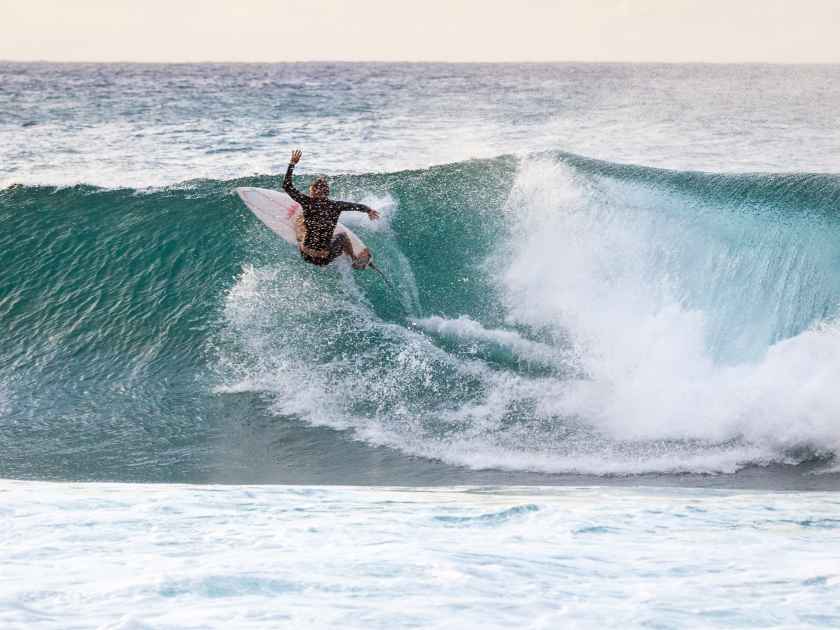 Surfing on the Banzai Pipeline wave break on Oahu North Shore in Hawaii, USA.