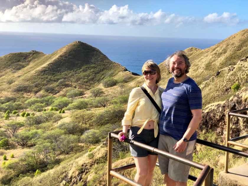 Married couple on vacation hugging and smiling. Diamond Head. Honolulu. Oahu. Hawaii.