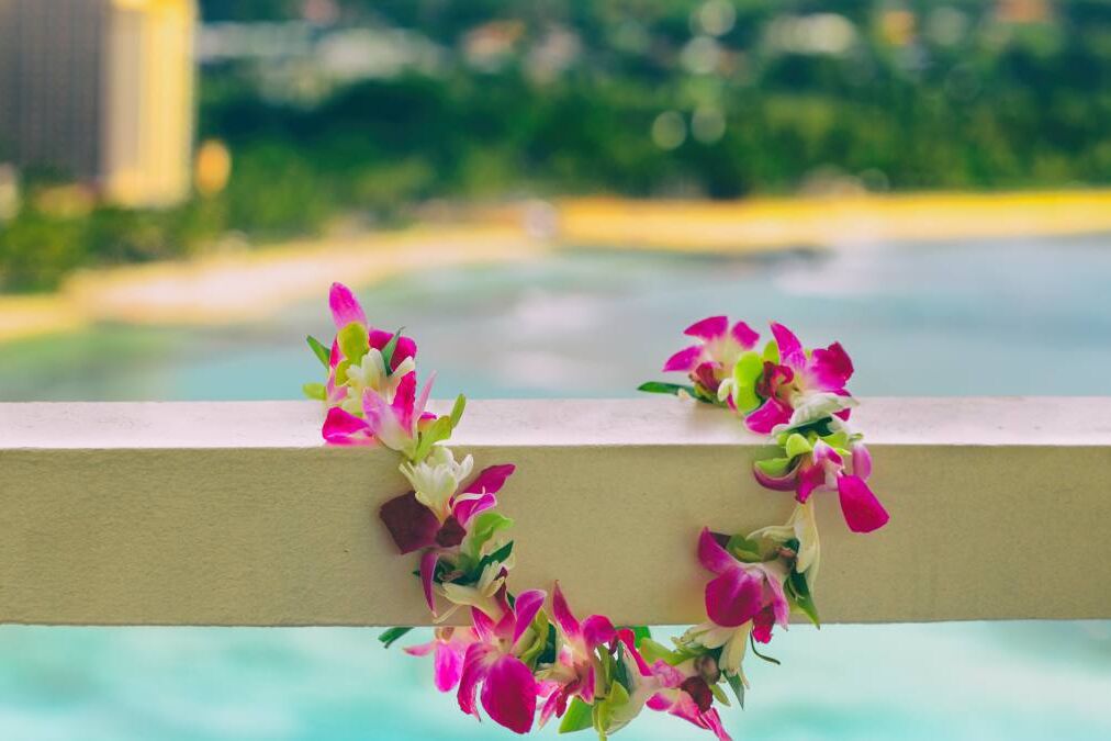 Hawaii background hawaiian flower lei with Waikiki beach landscape.