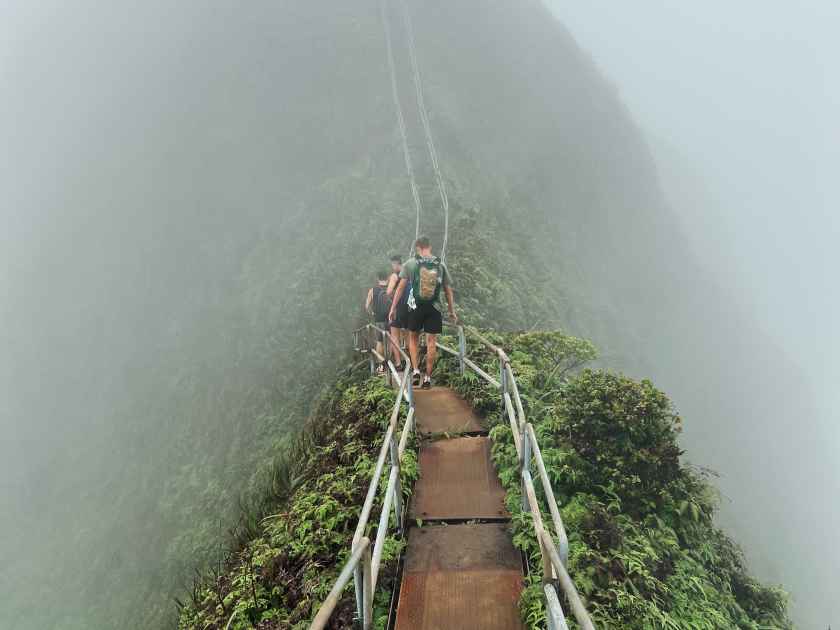 Man Hiking Stairway to Heaven (Haiku Stairs) on Oahu, Hawaii. High quality photo. Looking up the stairs.