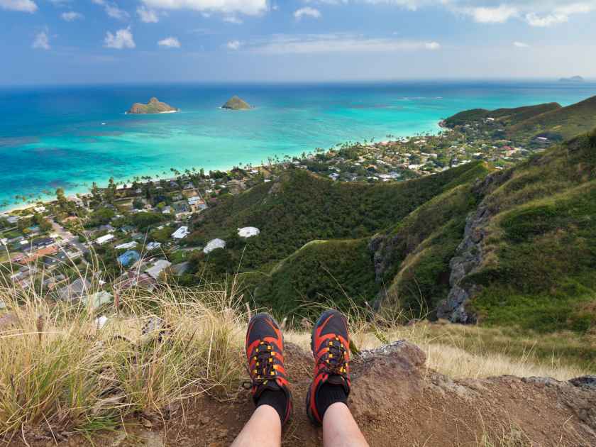 Enjoying the view on the Lanikai Pillboxes Trail in Oahu, Hawaii. View of the Lanikai Beach and the Mokulua Islands.