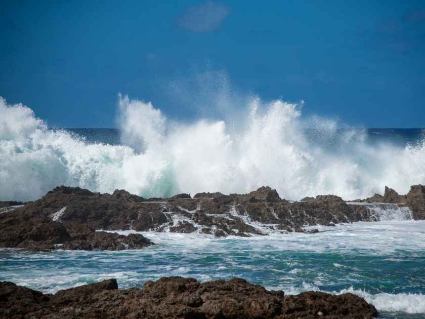 Huge waves crashing near Shark's cove on the north side of Oahu, Hawaii.