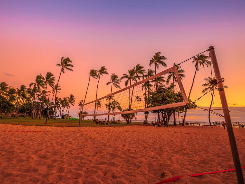 Beach volleyball net at sunset at Fort DeRussy Beach Park which is part of eight sections that make up the popular and long Waikiki Beach in Honolulu, Oahu, Hawaii.