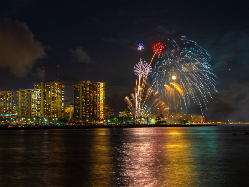 Fireworks seascape with moon and mars over waikiki skyline and diamond head crater landmark