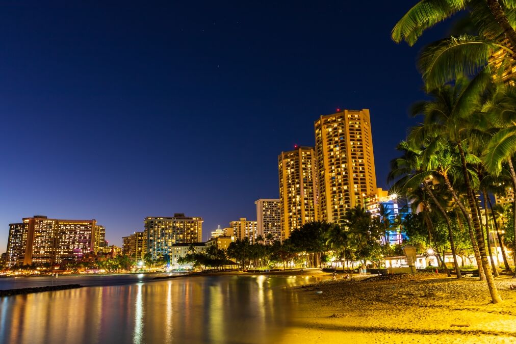 Beautiful view of Honolulu skyline and Waikiki beach at night in the island of Oahu, Hawaii, USA. Long exposure shot.