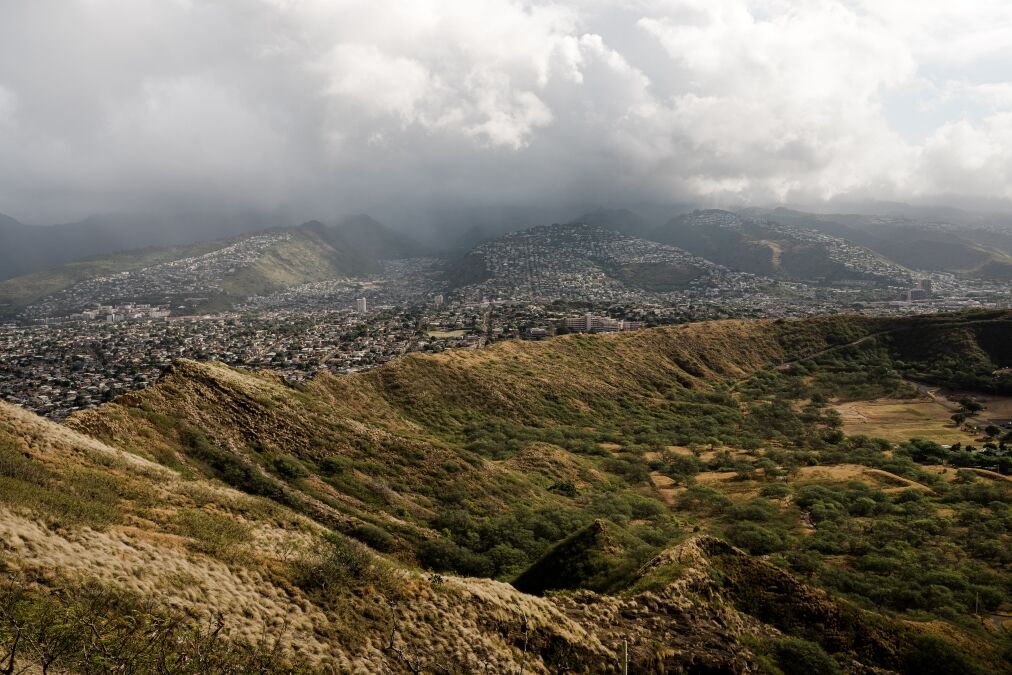 Dramatic views from the top of the Diamond Head Crater Hike on a bright but cloudy day.