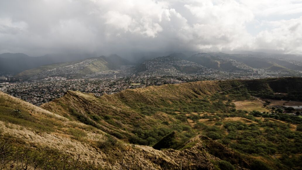 Dramatic views from the top of the Diamond Head Crater Hike on a bright but cloudy day.