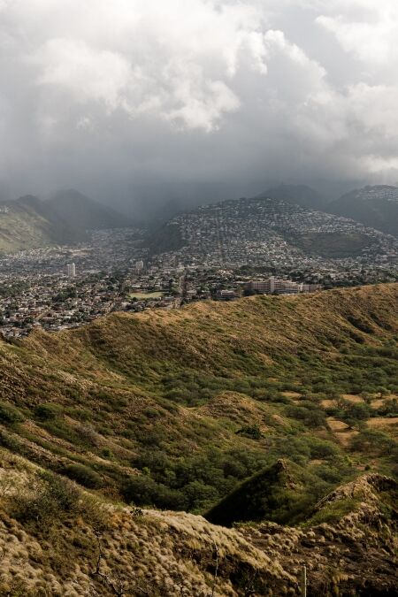 Dramatic views from the top of the Diamond Head Crater Hike on a bright but cloudy day.