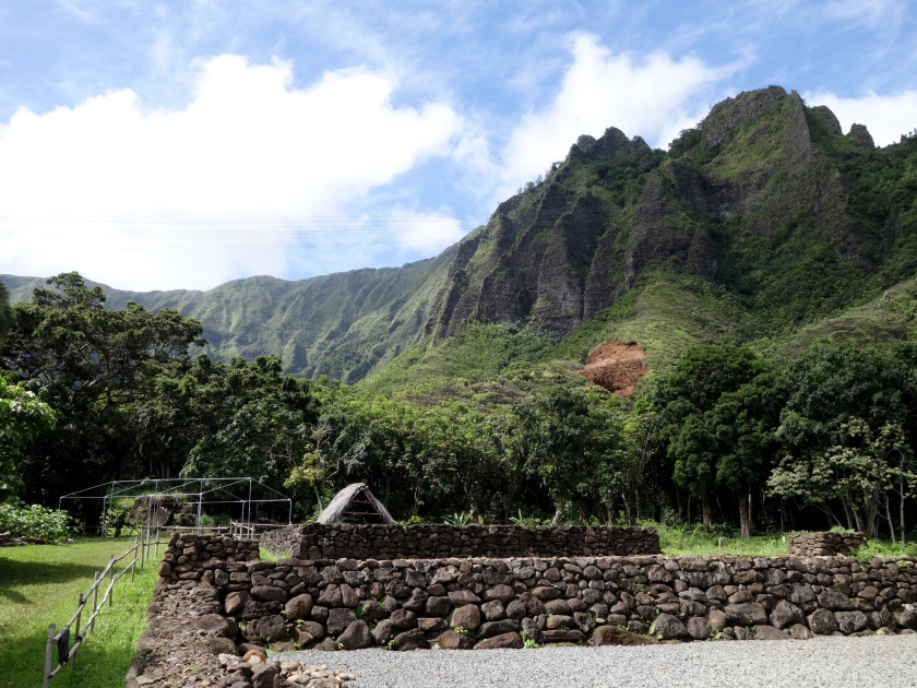 Restored Heiau on Windward Oahu with Trees and Mountains in the distance on a beautiful day.