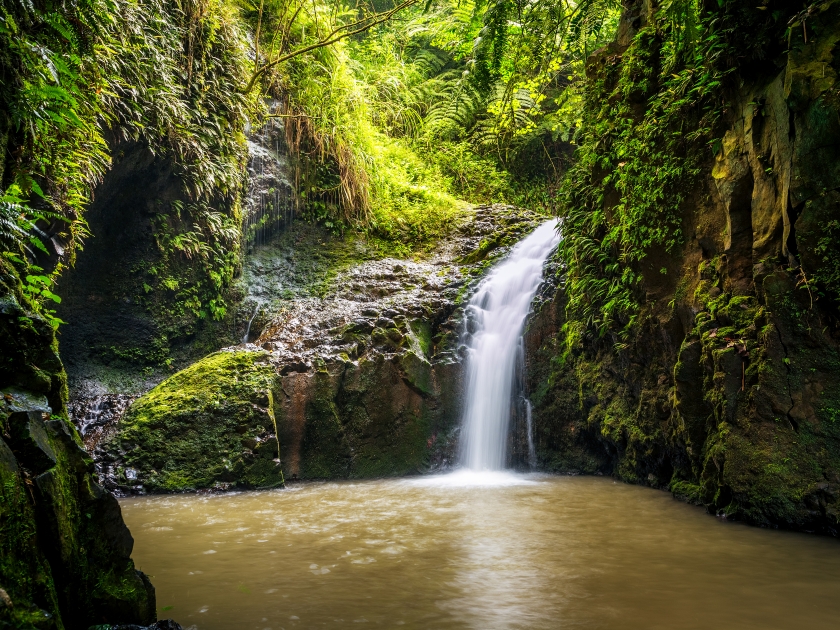 Maunawili water fall spills into a large pool below on the Hawaiian island of Oahu.