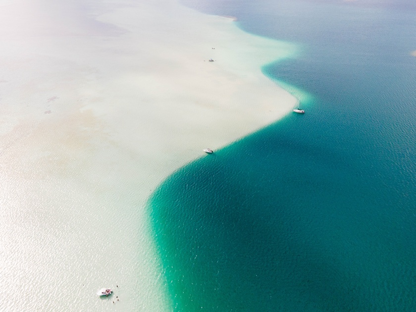 Drone,View,Of,Boats,Docked,Between,White,Sands,And,Clear