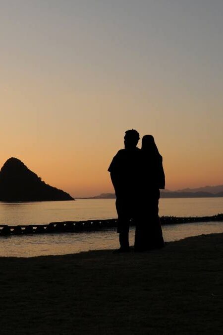 A Couple Enjoying A Chinaman's Hat Sunrise, Oahu, Hawaii