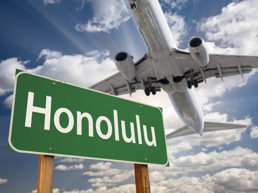Honolulu Green Road Sign and Airplane Above with Dramatic Blue Sky and Clouds.