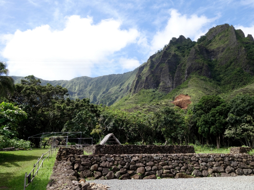 Restored Heiau on Windward Oahu with Trees and Mountains in the distance on a beautiful day.