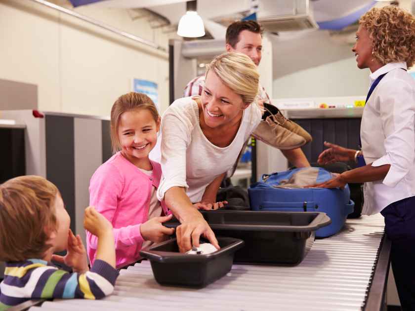 Family At Airport Passing Through Security Check