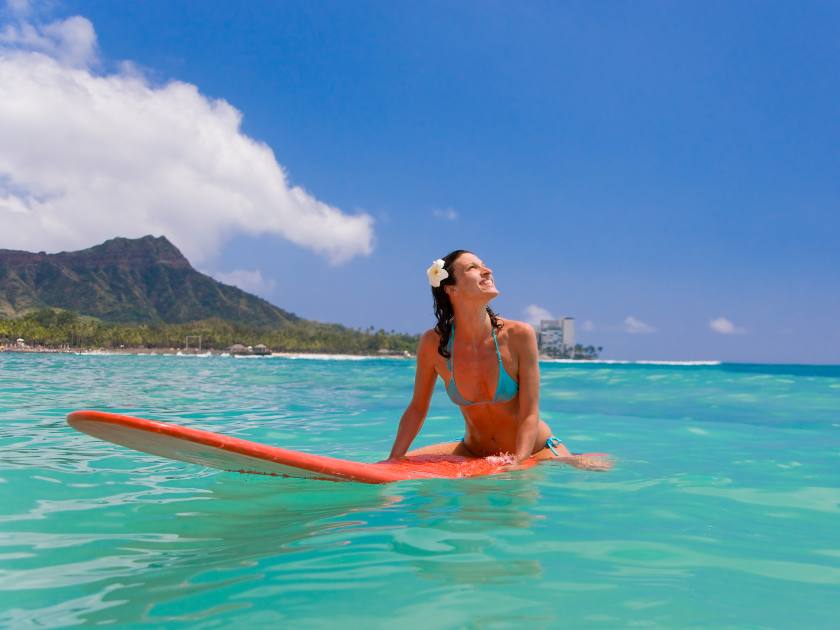 woman with red surfboard in waikiki, diamond head, oahu