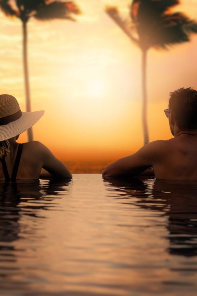 Couple,Enjoying,Sunset,From,Infinity,Pool,At,Tropical,Bali,Island
