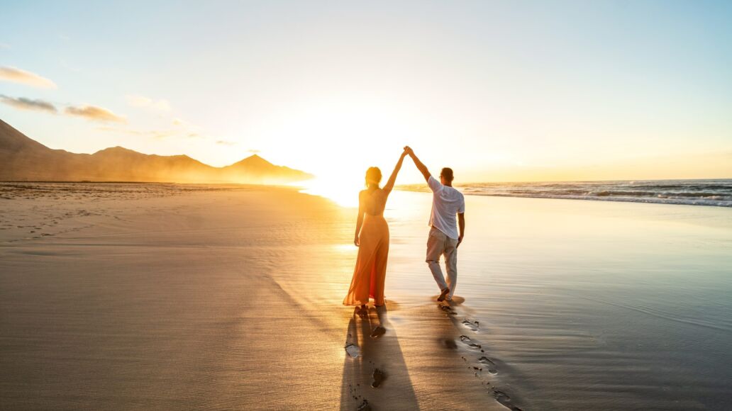 Lovely,,Romantic,Couple,Walking,On,Sunset,Beach,,Enjoying,Evening,Light,