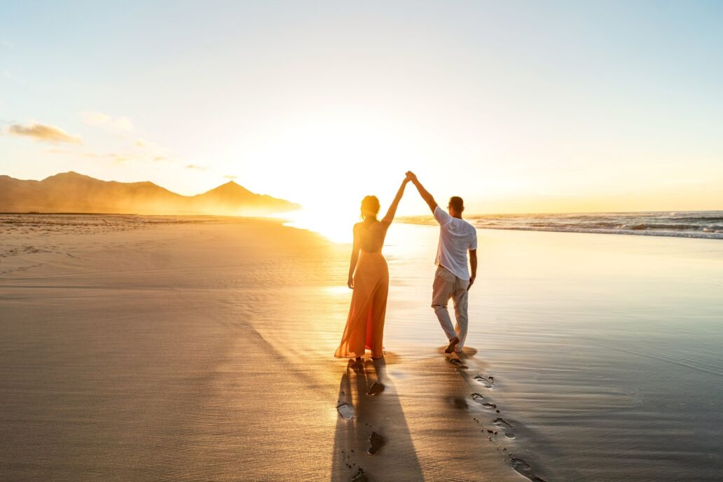 Lovely,,Romantic,Couple,Walking,On,Sunset,Beach,,Enjoying,Evening,Light,