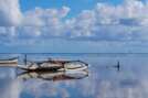 An Outrigger Canoe is Perfectly Mirrored in the Waters of Kaneohe Bay
