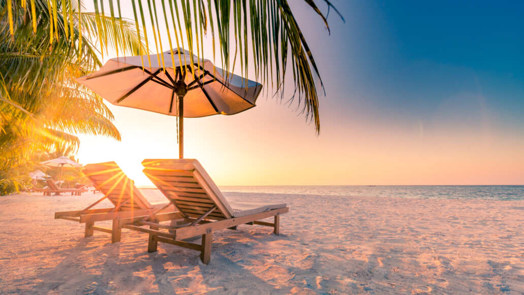 Long chairs and umbrella by the beach